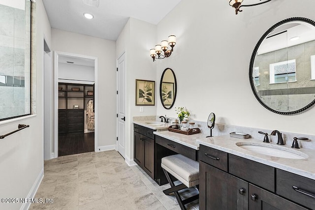 full bathroom with double vanity, baseboards, and a sink