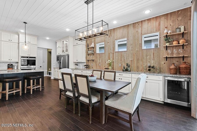 dining space with beverage cooler, wooden walls, wood ceiling, dark wood-style flooring, and recessed lighting