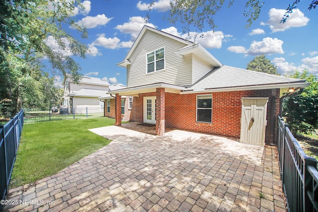 2534 Willow Creek Dr, Fleming Island, FL 32003 - back of house with brick siding, a fenced backyard, a patio, and roof with shingles