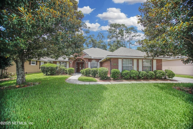 2534 Willow Creek Dr, Fleming Island, FL 32003 - single story home featuring brick siding, a front lawn, and a shingled roof