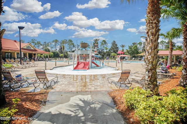 2534 Willow Creek Dr, Fleming Island, FL 32003 - view of play area with a community pool, a patio area, and a water play area