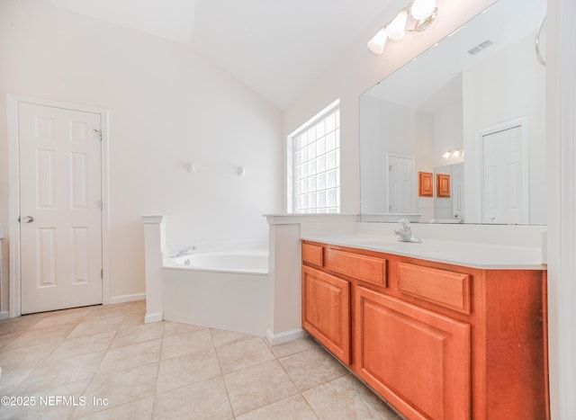 2534 Willow Creek Dr, Fleming Island, FL 32003 - bathroom with vanity, a garden tub, tile patterned flooring, and vaulted ceiling
