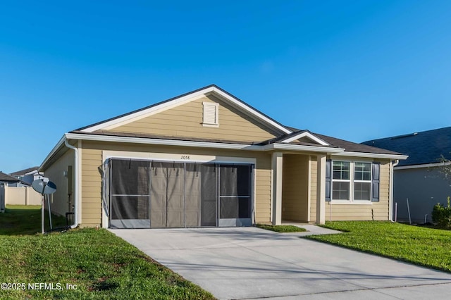 ranch-style home featuring concrete driveway, an attached garage, and a front lawn