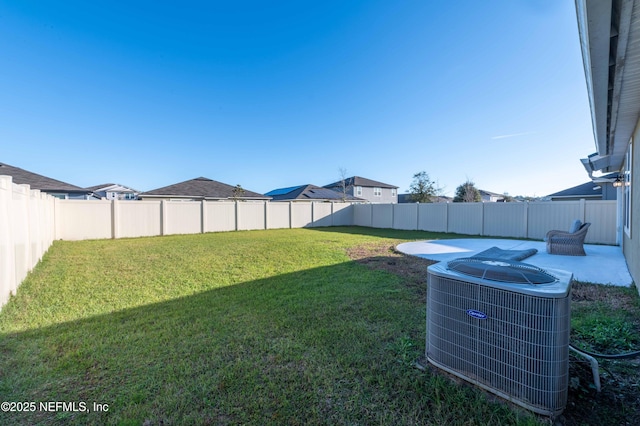 view of yard featuring central AC and a fenced backyard