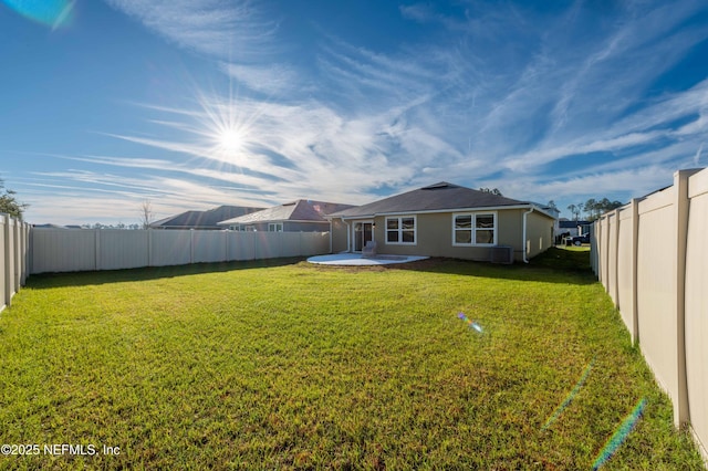 back of house featuring a yard, a patio area, and a fenced backyard