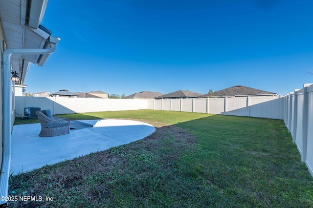 view of yard with a fenced backyard, cooling unit, and a patio