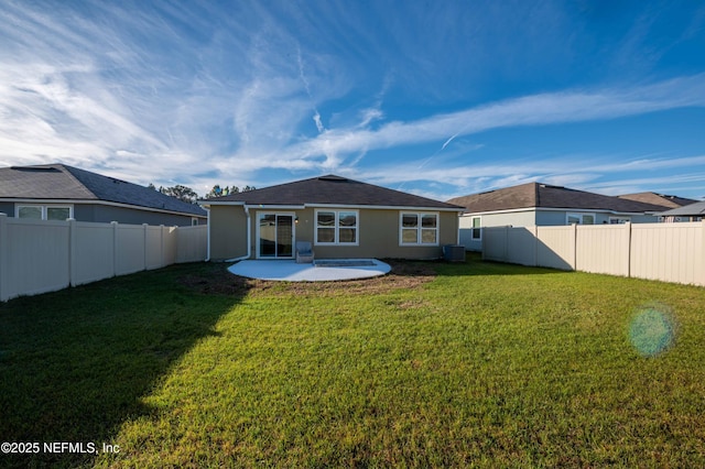 rear view of property with a patio area, a fenced backyard, a lawn, and stucco siding