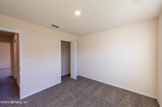 unfurnished bedroom featuring carpet floors, a closet, visible vents, and baseboards