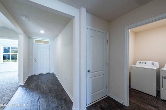 entrance foyer featuring baseboards, visible vents, washer and clothes dryer, and wood finished floors