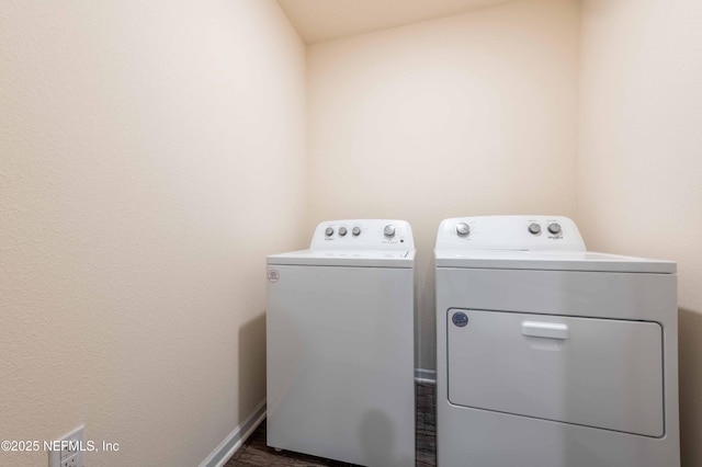 clothes washing area with washer and dryer, laundry area, and baseboards