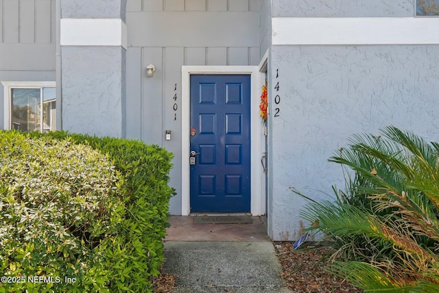 doorway to property featuring board and batten siding