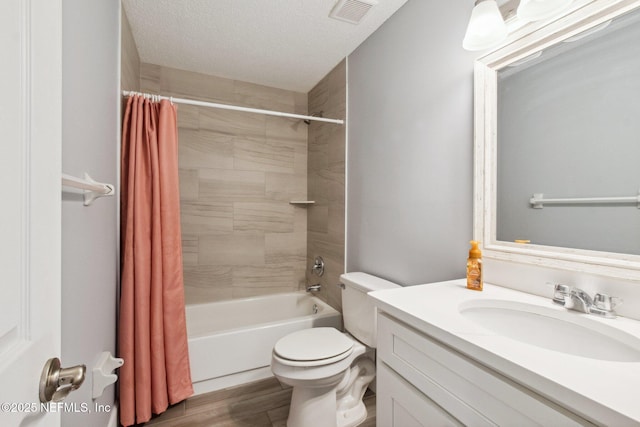 bathroom featuring visible vents, toilet, wood finished floors, shower / bathtub combination with curtain, and a textured ceiling