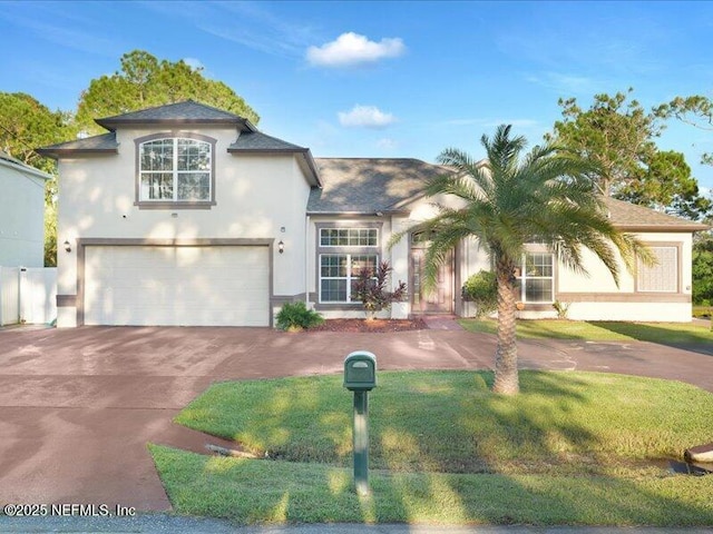 view of front of home with driveway, an attached garage, a front lawn, and stucco siding