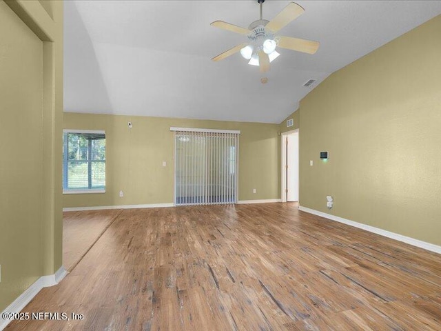 unfurnished living room with visible vents, vaulted ceiling, baseboards, and wood finished floors