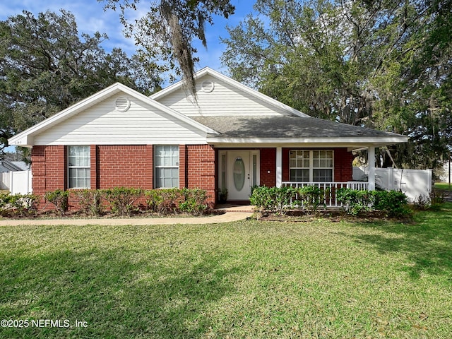 single story home featuring brick siding, a front lawn, and a porch