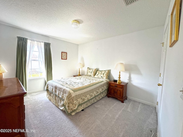 bedroom featuring light carpet, a textured ceiling, visible vents, and baseboards