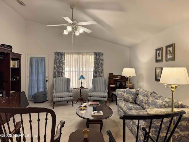 living room featuring lofted ceiling, carpet flooring, visible vents, and a ceiling fan