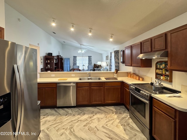 kitchen with a peninsula, stainless steel appliances, light countertops, under cabinet range hood, and a sink