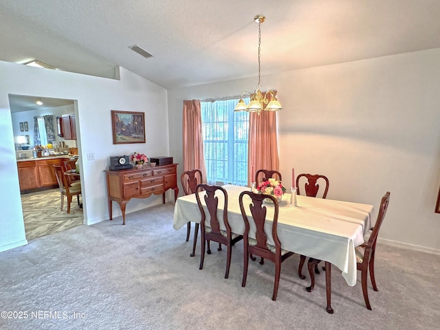 dining area featuring lofted ceiling, light carpet, visible vents, and a chandelier