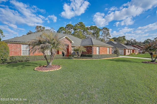 single story home featuring brick siding and a front yard