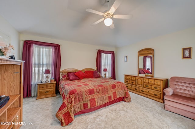 carpeted bedroom with lofted ceiling and ceiling fan