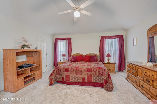 bedroom with ceiling fan, multiple windows, and carpet flooring