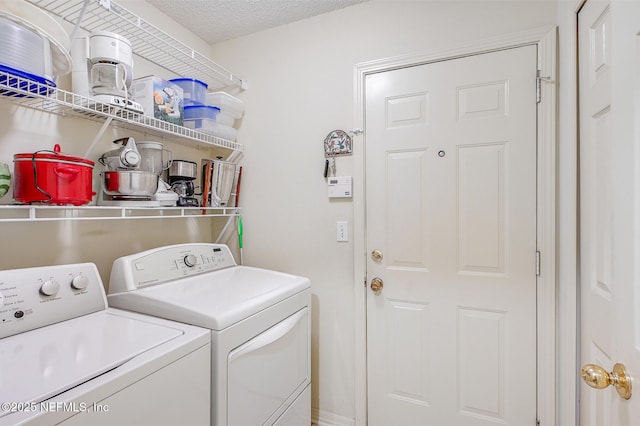 laundry area with a textured ceiling, laundry area, and separate washer and dryer