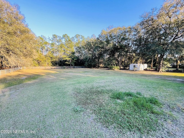 view of yard featuring a storage shed and an outdoor structure