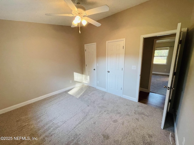 unfurnished bedroom with carpet, ceiling fan, and baseboards