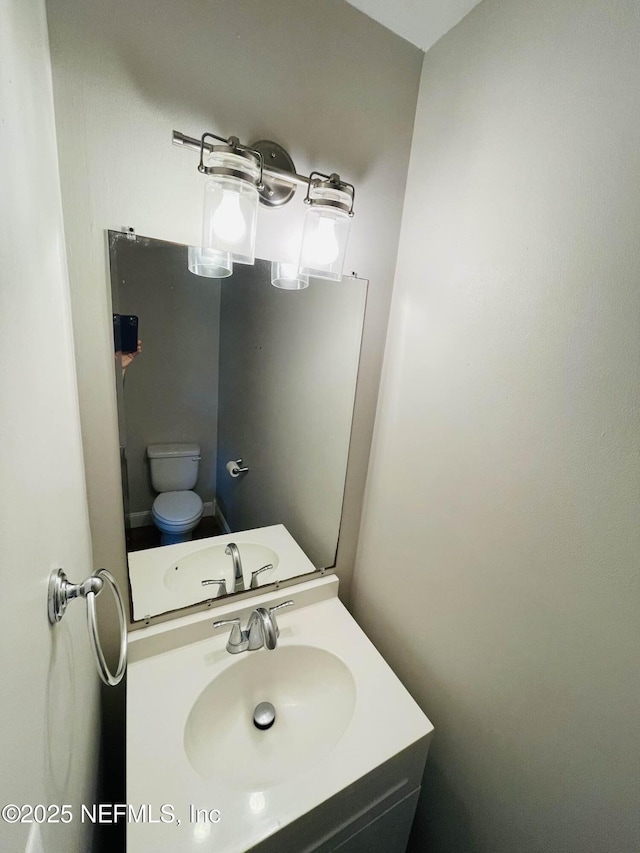 bathroom featuring vanity and toilet