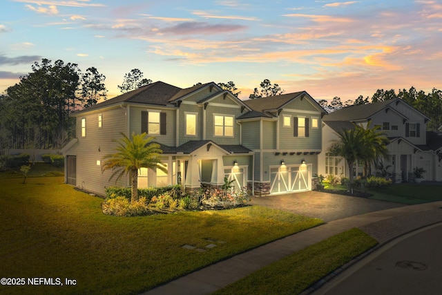 view of front of property with a front lawn, a garage, and aphalt driveway