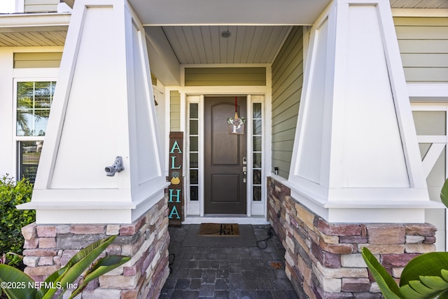 view of exterior entry featuring stone siding