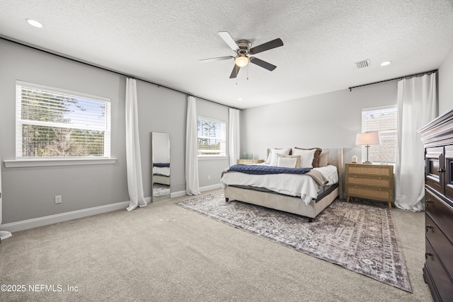 bedroom with a textured ceiling, recessed lighting, carpet floors, baseboards, and ceiling fan