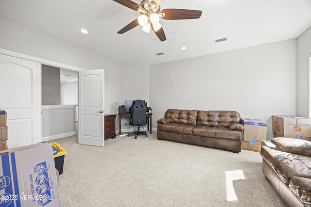 living area with visible vents, baseboards, light carpet, recessed lighting, and a ceiling fan