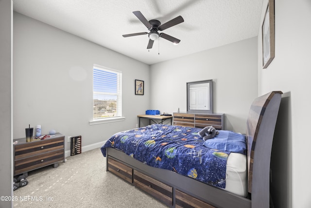 bedroom with a ceiling fan, baseboards, carpet floors, and a textured ceiling