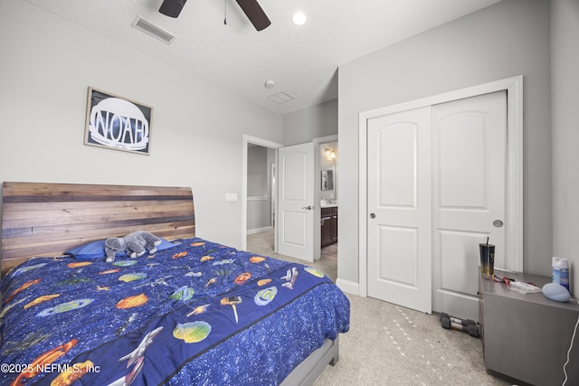 bedroom featuring visible vents, a textured ceiling, a closet, carpet, and ceiling fan