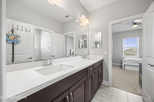 ensuite bathroom with double vanity, a ceiling fan, ensuite bathroom, and a sink