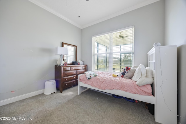 carpeted bedroom featuring crown molding and baseboards