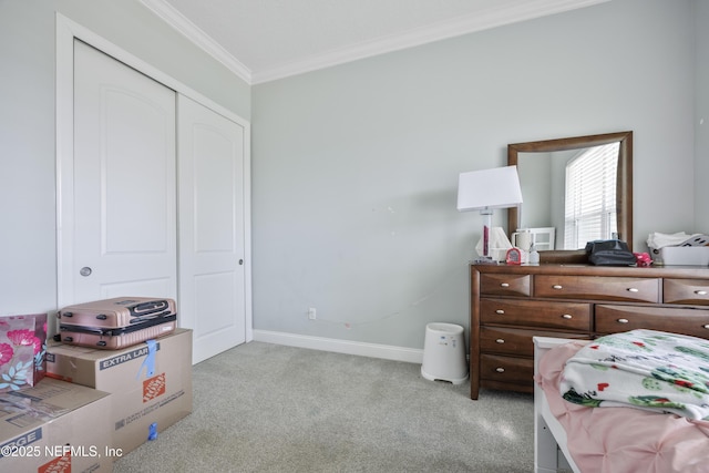 carpeted bedroom featuring a closet, baseboards, and ornamental molding