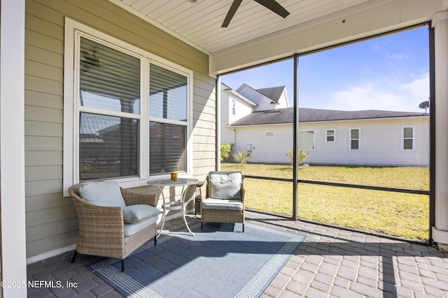 sunroom featuring a ceiling fan