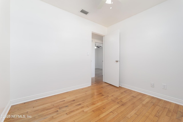 unfurnished room with light wood finished floors, ceiling fan, visible vents, and baseboards