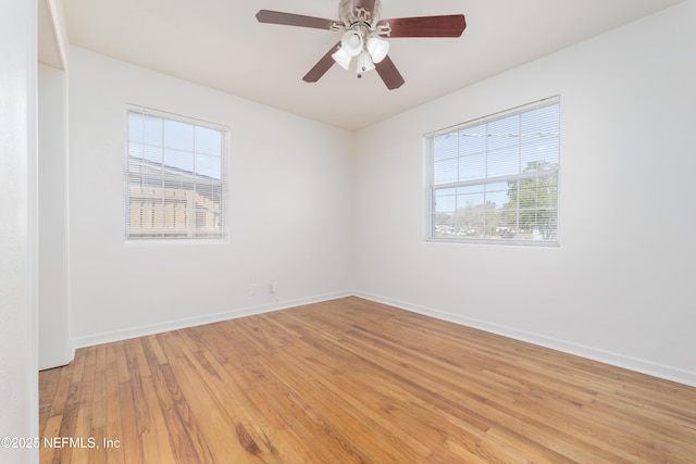 spare room featuring baseboards, ceiling fan, and light wood-style floors