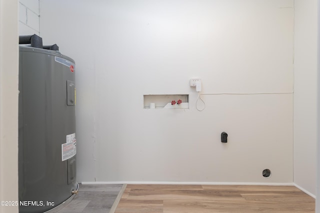 washroom featuring washer hookup, laundry area, electric water heater, and light wood finished floors