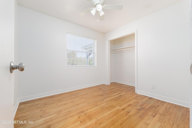 unfurnished bedroom with light wood-style floors, a closet, baseboards, and a ceiling fan