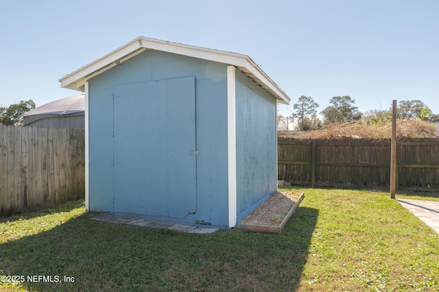 view of shed with a fenced backyard