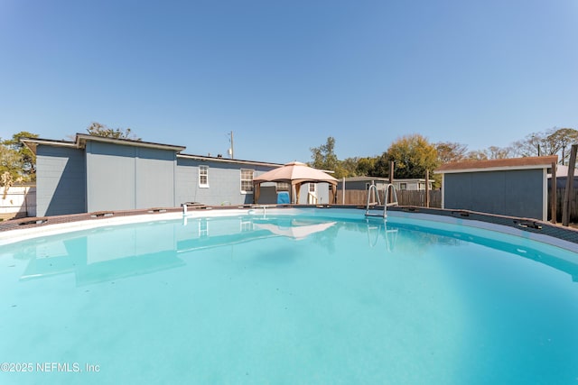 view of pool featuring a fenced in pool, fence, and an outdoor structure