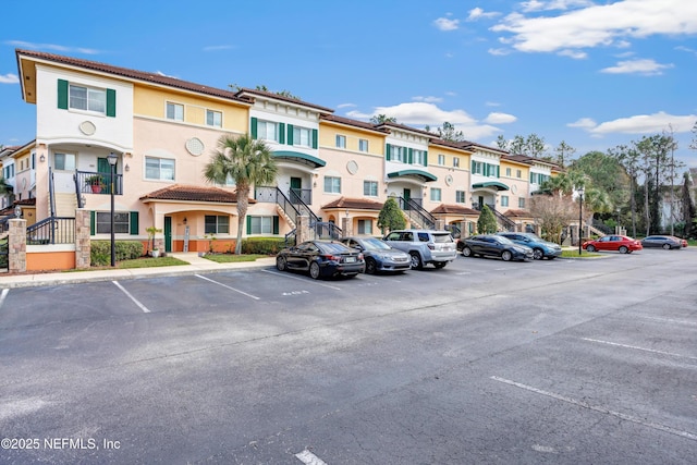 uncovered parking lot featuring a residential view