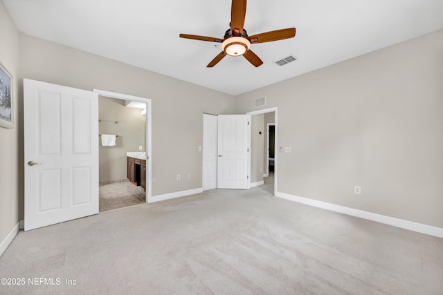 unfurnished bedroom featuring baseboards, visible vents, and light colored carpet