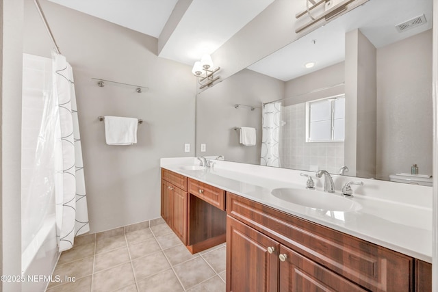 full bath featuring double vanity, tile patterned flooring, a sink, and visible vents