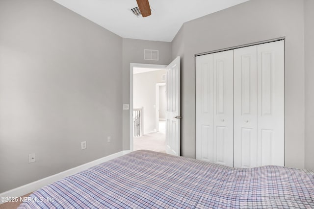 unfurnished bedroom with a closet, visible vents, and baseboards